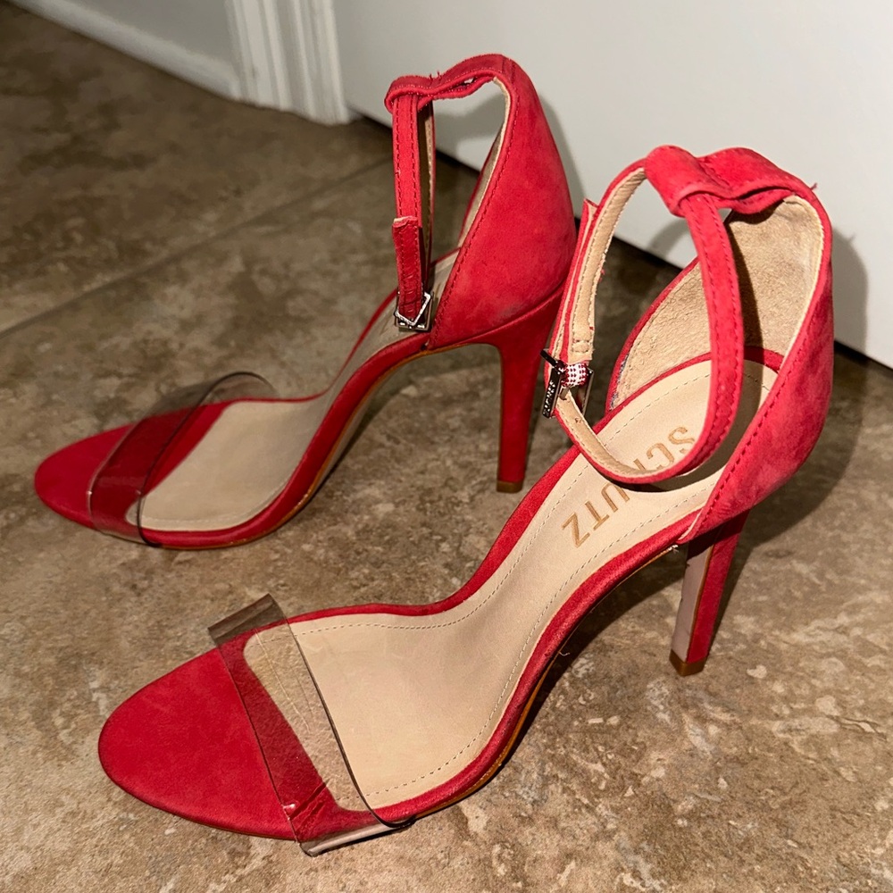 Brand: SCHUTZ
4.25 inch red suede stiletto with a clear front strap size 7.5
